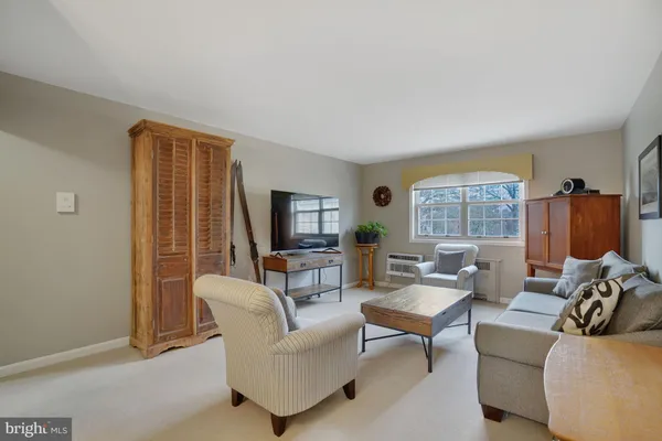 a living room with furniture a chandelier and a table