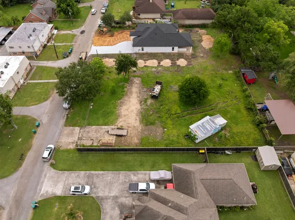 an aerial view of a house with a yard