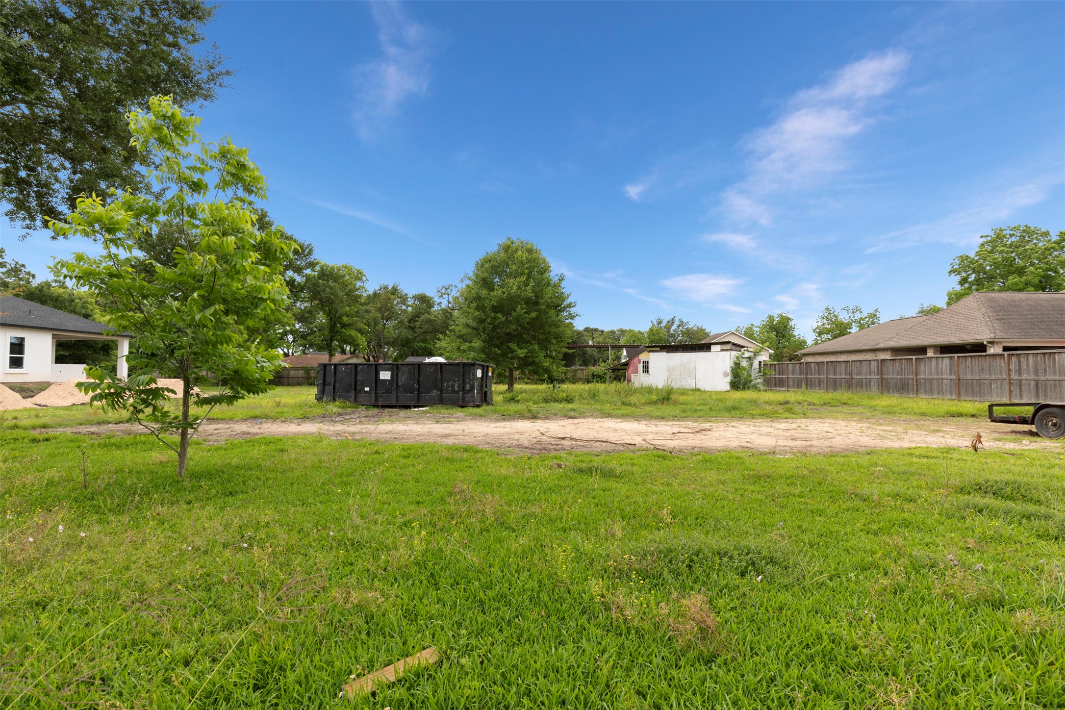 410 Spring Drive Pasadena, TX 77504 - Photo 9 of 18 a view of yard with swimming pool and trees in the background
