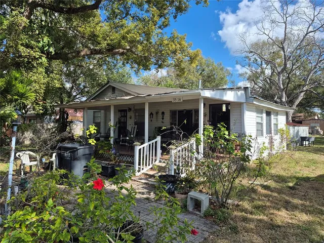 a front view of a house with sitting area and garden