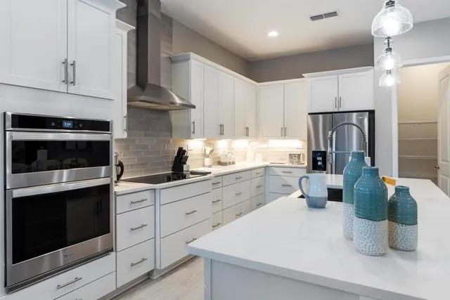 a kitchen with a sink a counter top stainless steel appliances and cabinets