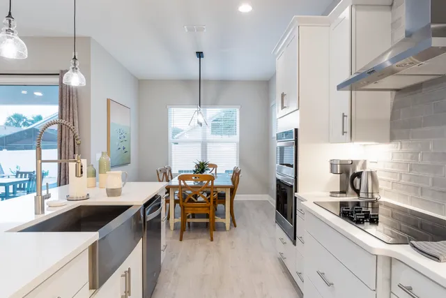 a kitchen with stainless steel appliances kitchen island granite countertop a sink and refrigerator