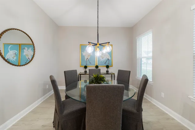 a large bed sitting in a bedroom and a flat tv screen on dresser