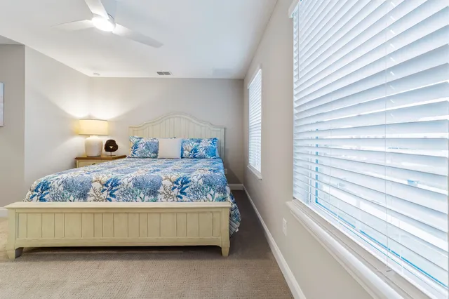 a bedroom with a bed and a lamp