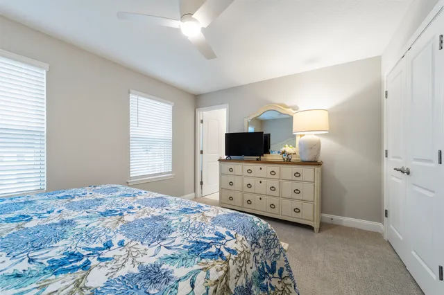 a bedroom with a bed and a night stand