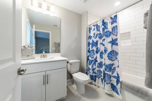 a bed room with a bed a television and a window