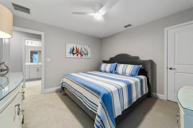 a bedroom with a large bed and a flat tv screen on dresser