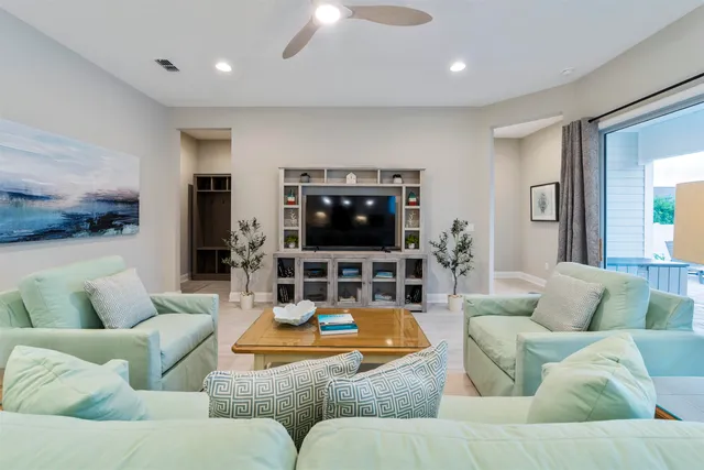 a kitchen with a refrigerator and white cabinets