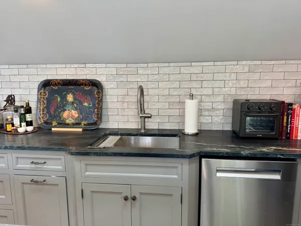 a kitchen with stainless steel appliances granite countertop white cabinets and a granite counter tops