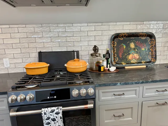 a kitchen with stainless steel appliances granite countertop a stove and a sink