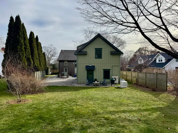a view of a house with a yard and sitting area
