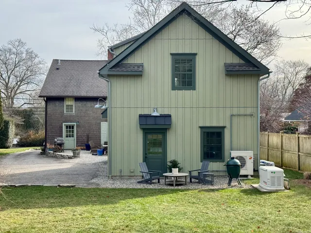 a front view of a house with outdoor seating