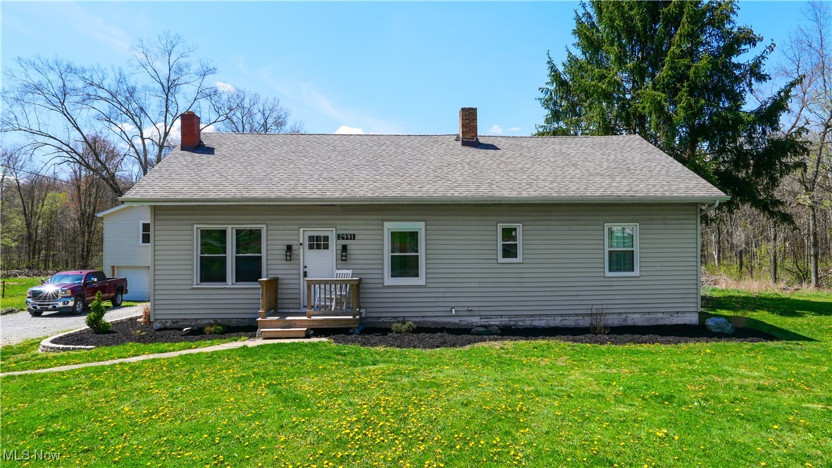 2991 Bushnell Campbell Road Fowler, OH 44418 - Photo 24 of 41 View of front of house with a front yard, a shingled roof, and a chimney