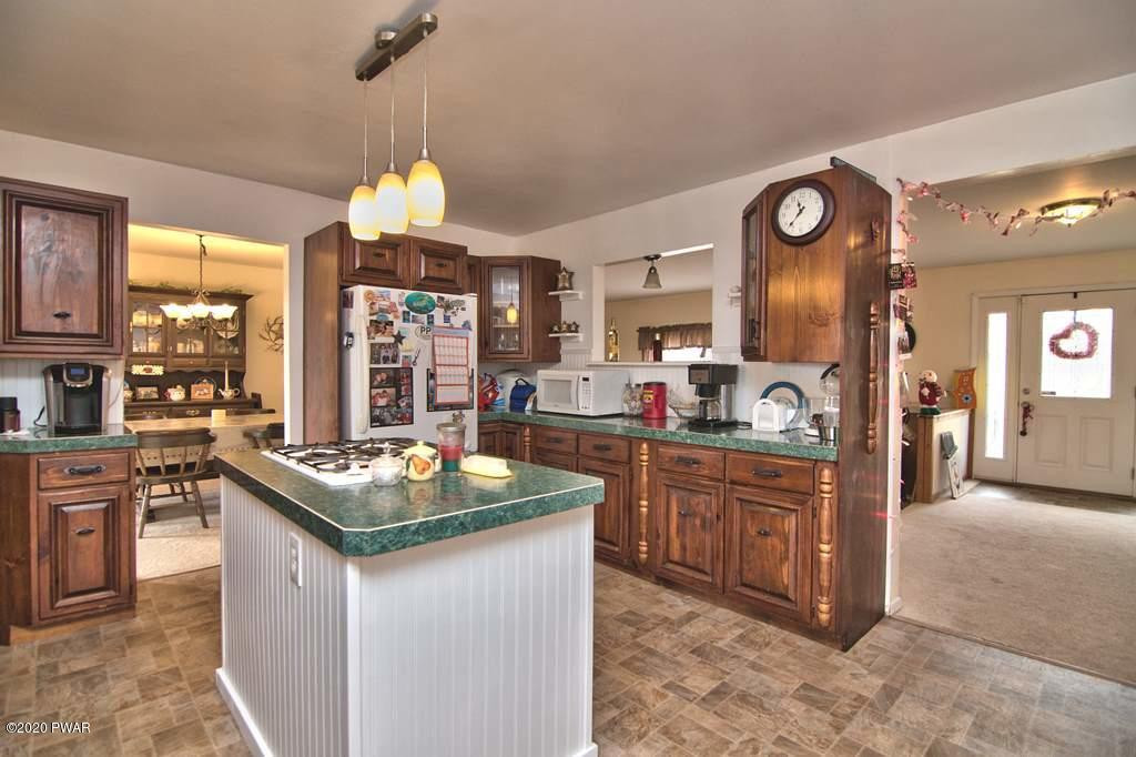 682 Stock Farm Road Lake Ariel, PA 18436 - Photo 25 of 78 a kitchen with granite countertop a sink stove and cabinets
