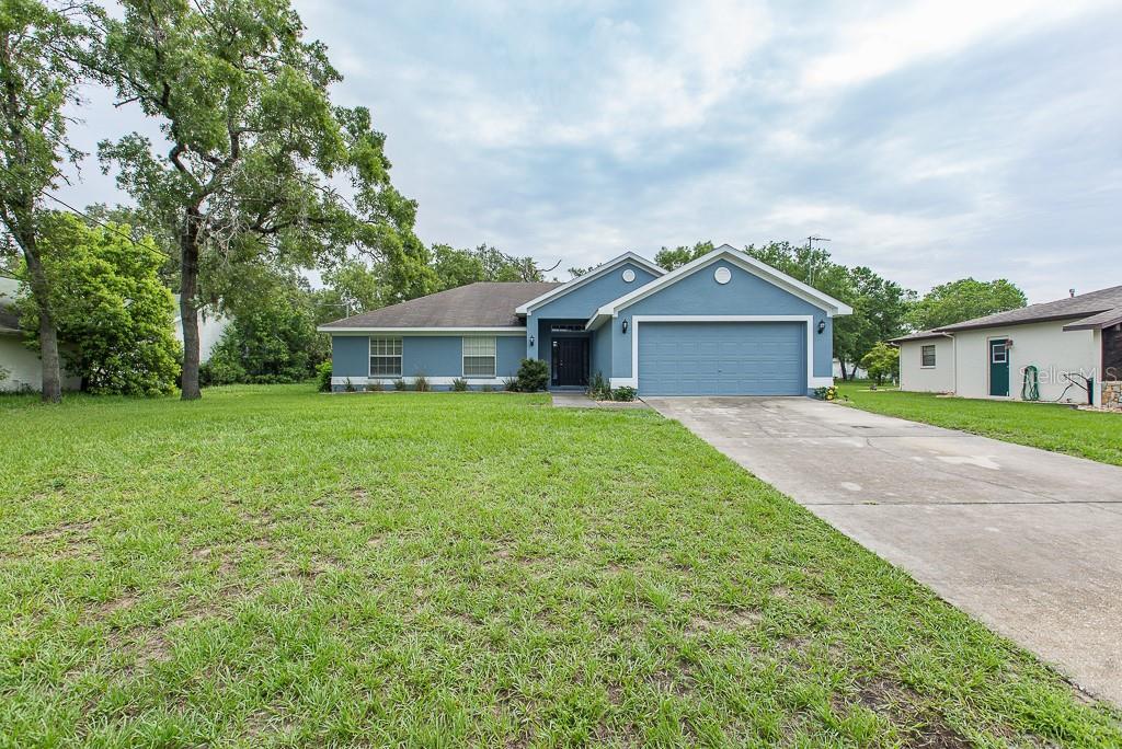 11389 Regent Lane Spring Hill, FL 34609 - Photo 1 of 1 Front of the Home with Extended Driveway