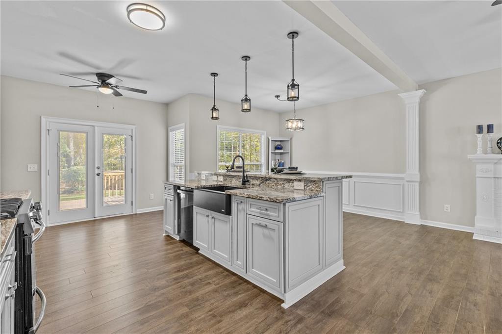 4230 Jonathan Lane Cumming, GA 30040 - Photo 16 of 57 a kitchen with stainless steel appliances granite countertop a white stove top oven and a chandelier