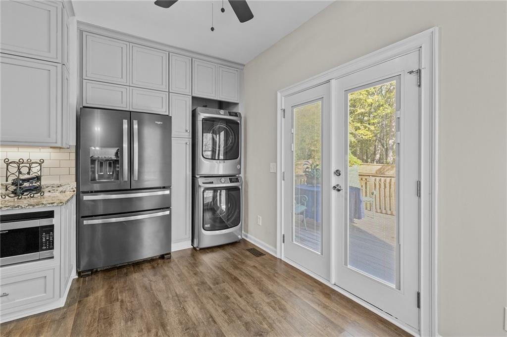 4230 Jonathan Lane Cumming, GA 30040 - Photo 18 of 57 a kitchen with stainless steel appliances a refrigerator and a hard wood floor
