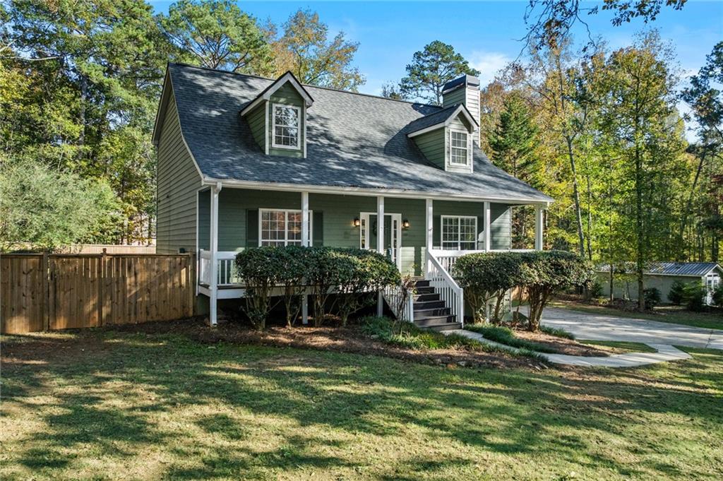 4230 Jonathan Lane Cumming, GA 30040 - Photo 2 of 57 a view of house with yard in front of it