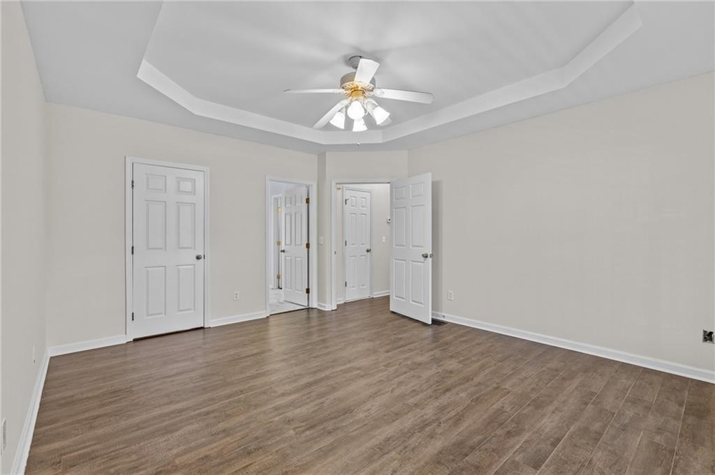 4230 Jonathan Lane Cumming, GA 30040 - Photo 24 of 57 a view of an empty room with wooden floor
