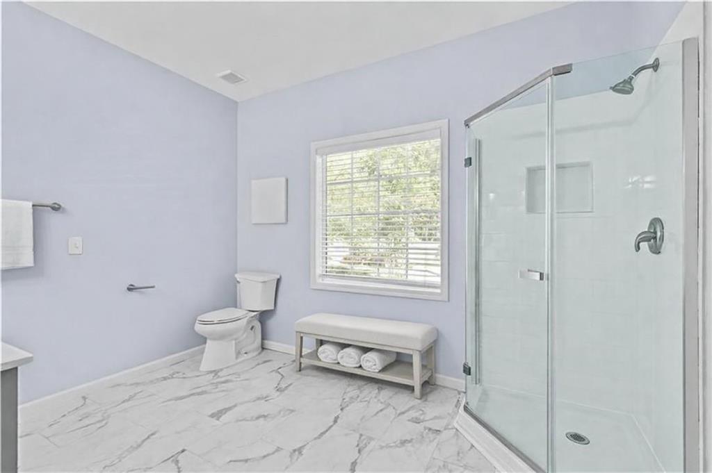 4230 Jonathan Lane Cumming, GA 30040 - Photo 25 of 57 a bathroom with a toilet a sink and shower