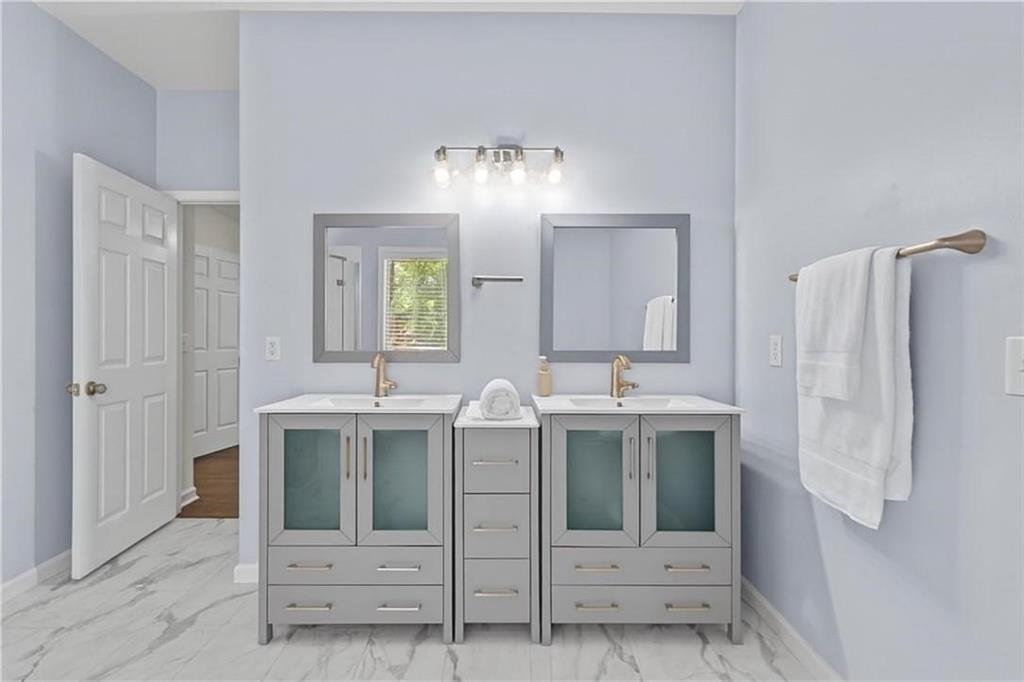 4230 Jonathan Lane Cumming, GA 30040 - Photo 27 of 57 a bathroom with a sink and a mirror