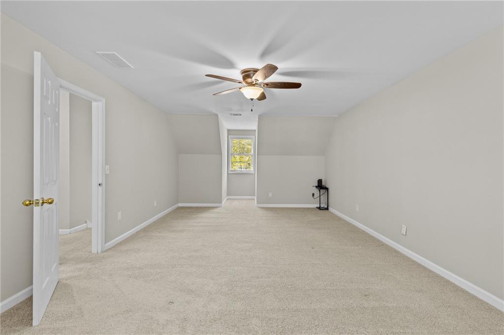 4230 Jonathan Lane Cumming, GA 30040 - Photo 30 of 57 an empty room with windows and fan chandelier fan