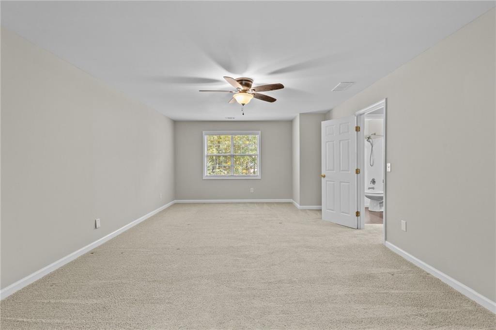 4230 Jonathan Lane Cumming, GA 30040 - Photo 31 of 57 an empty room with a window and a fan