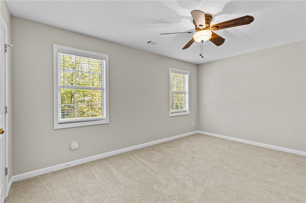 4230 Jonathan Lane Cumming, GA 30040 - Photo 32 of 57 an empty room with windows and fan