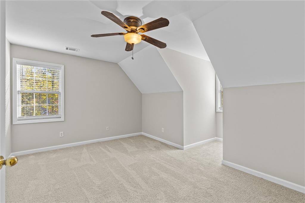4230 Jonathan Lane Cumming, GA 30040 - Photo 35 of 57 an empty room with windows and fan