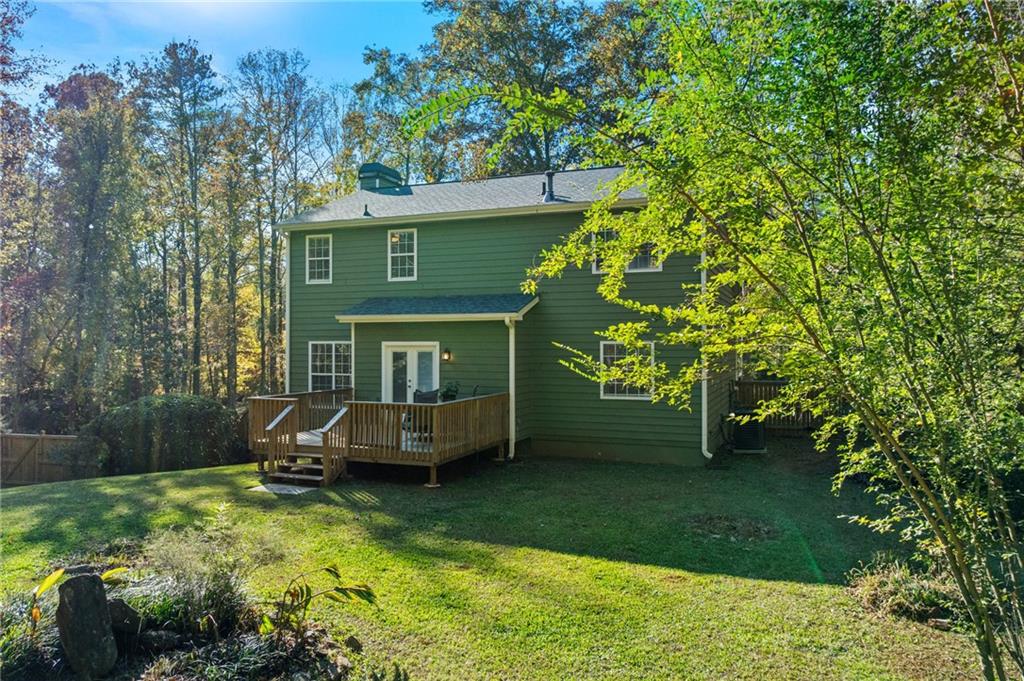 4230 Jonathan Lane Cumming, GA 30040 - Photo 49 of 57 a front view of a house with garden