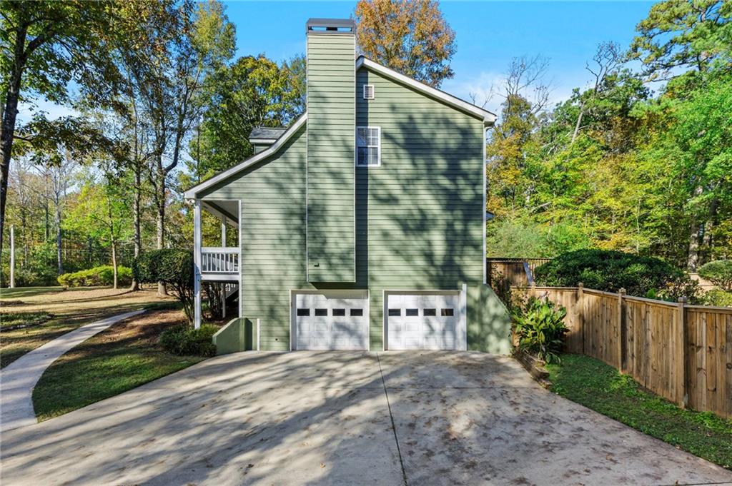 4230 Jonathan Lane Cumming, GA 30040 - Photo 50 of 57 a front view of a house with a yard and garage