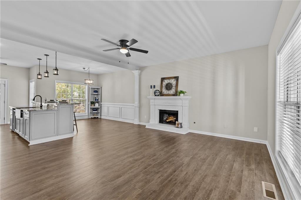 4230 Jonathan Lane Cumming, GA 30040 - Photo 7 of 57 a view of a kitchen with furniture wooden floor and a window