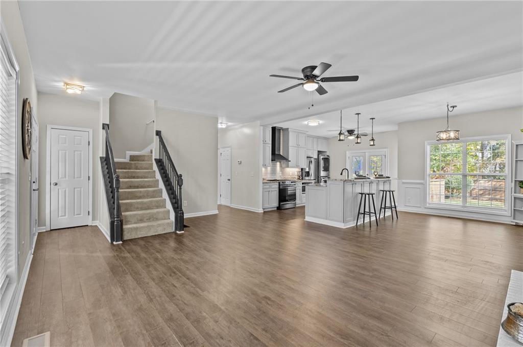 4230 Jonathan Lane Cumming, GA 30040 - Photo 9 of 57 a view of an empty room with wooden floor kitchen view and a window