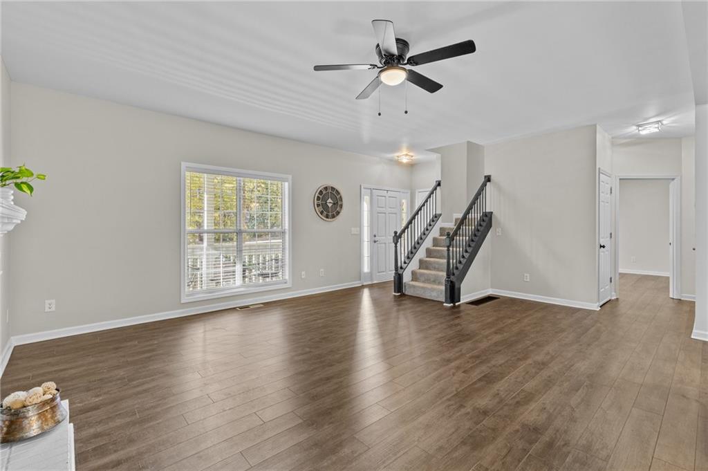 4230 Jonathan Lane Cumming, GA 30040 - Photo 10 of 57 a view of an empty room with wooden floor and a window