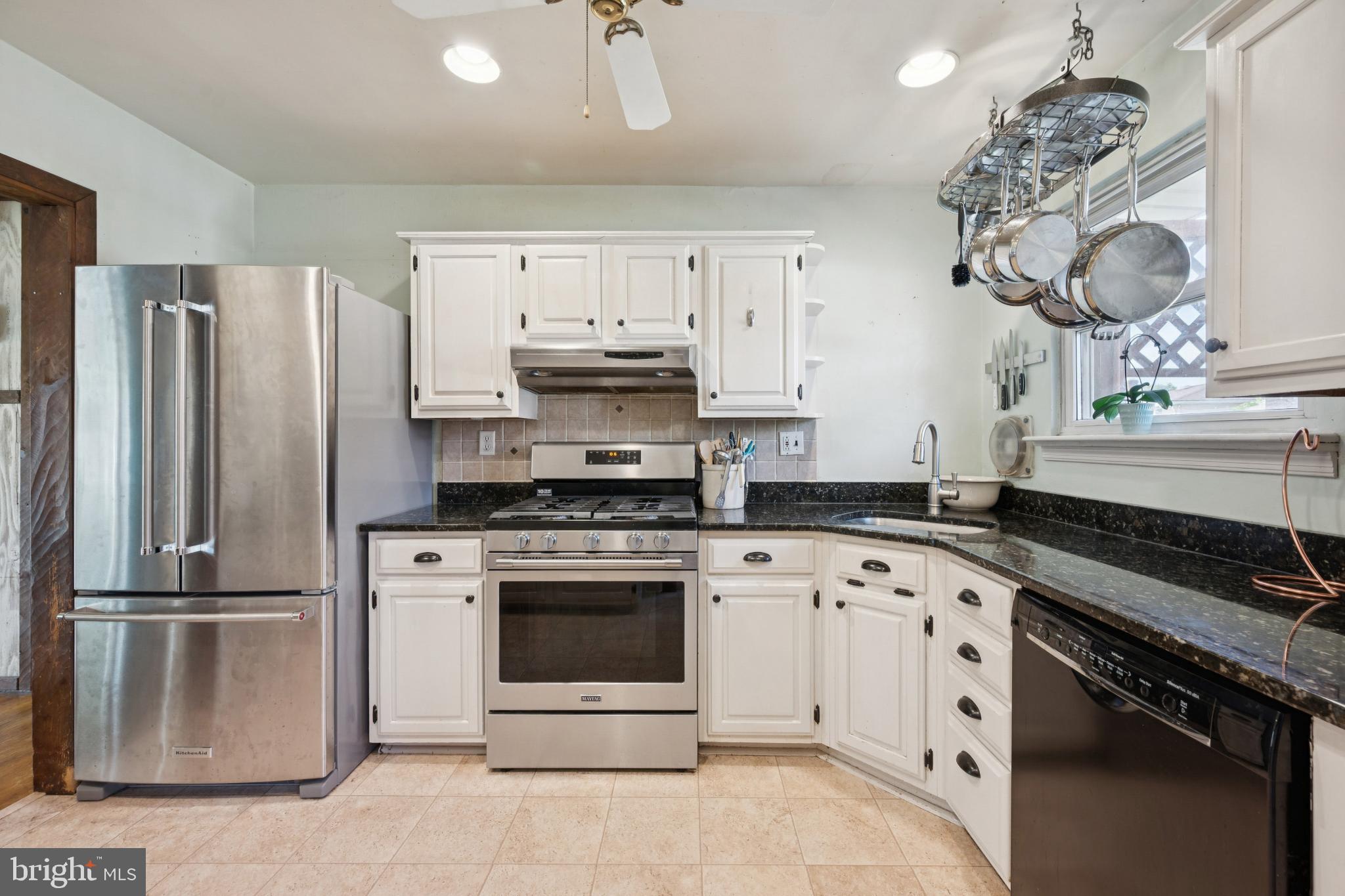 43 Princeton Drive Delran, NJ 08075 - Photo 11 of 25 a kitchen with stainless steel appliances a stove a sink and a refrigerator