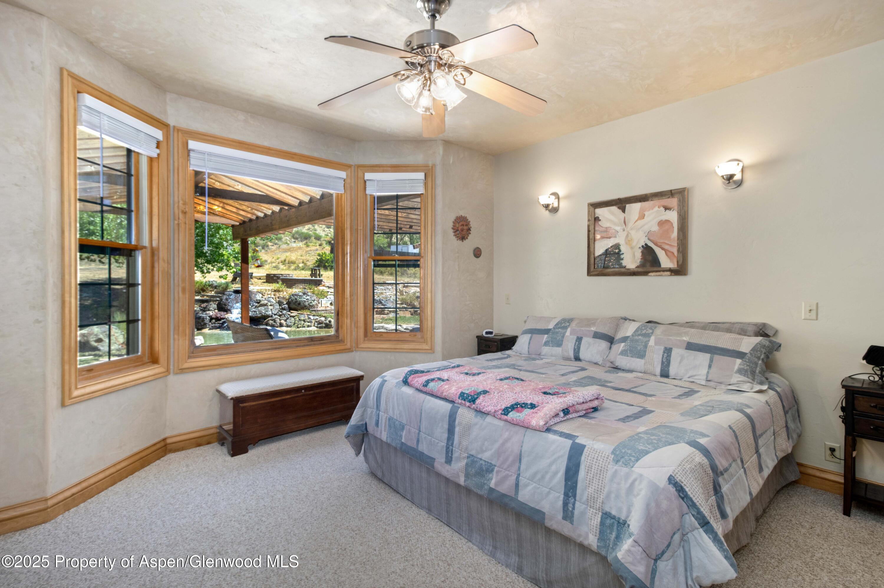 2687 Fairview Heights Court Rifle, CO 81650 - Photo 13 of 40 a bedroom with a bed and a large window