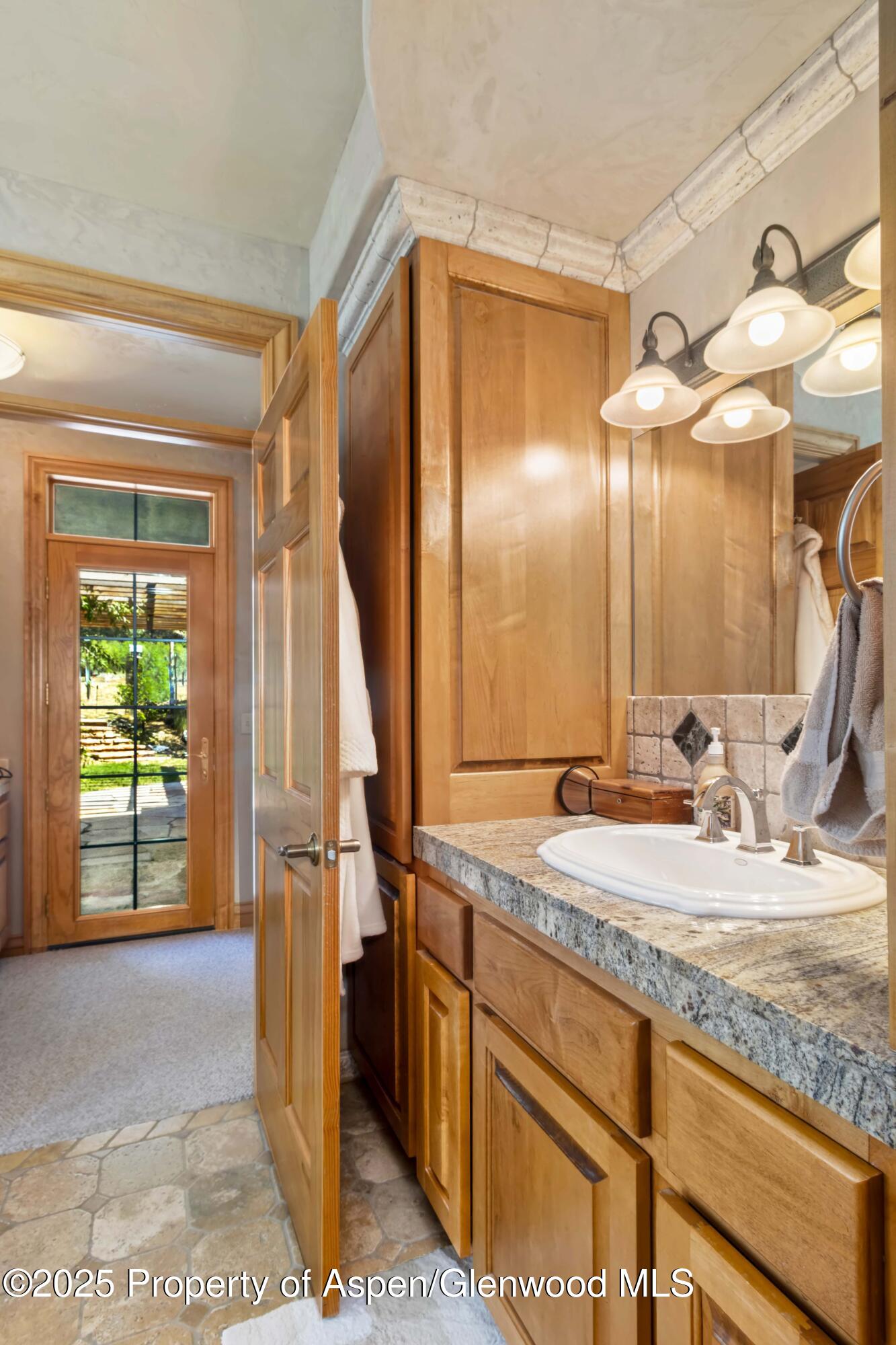 2687 Fairview Heights Court Rifle, CO 81650 - Photo 17 of 40 a bathroom with a granite countertop sink and a mirror