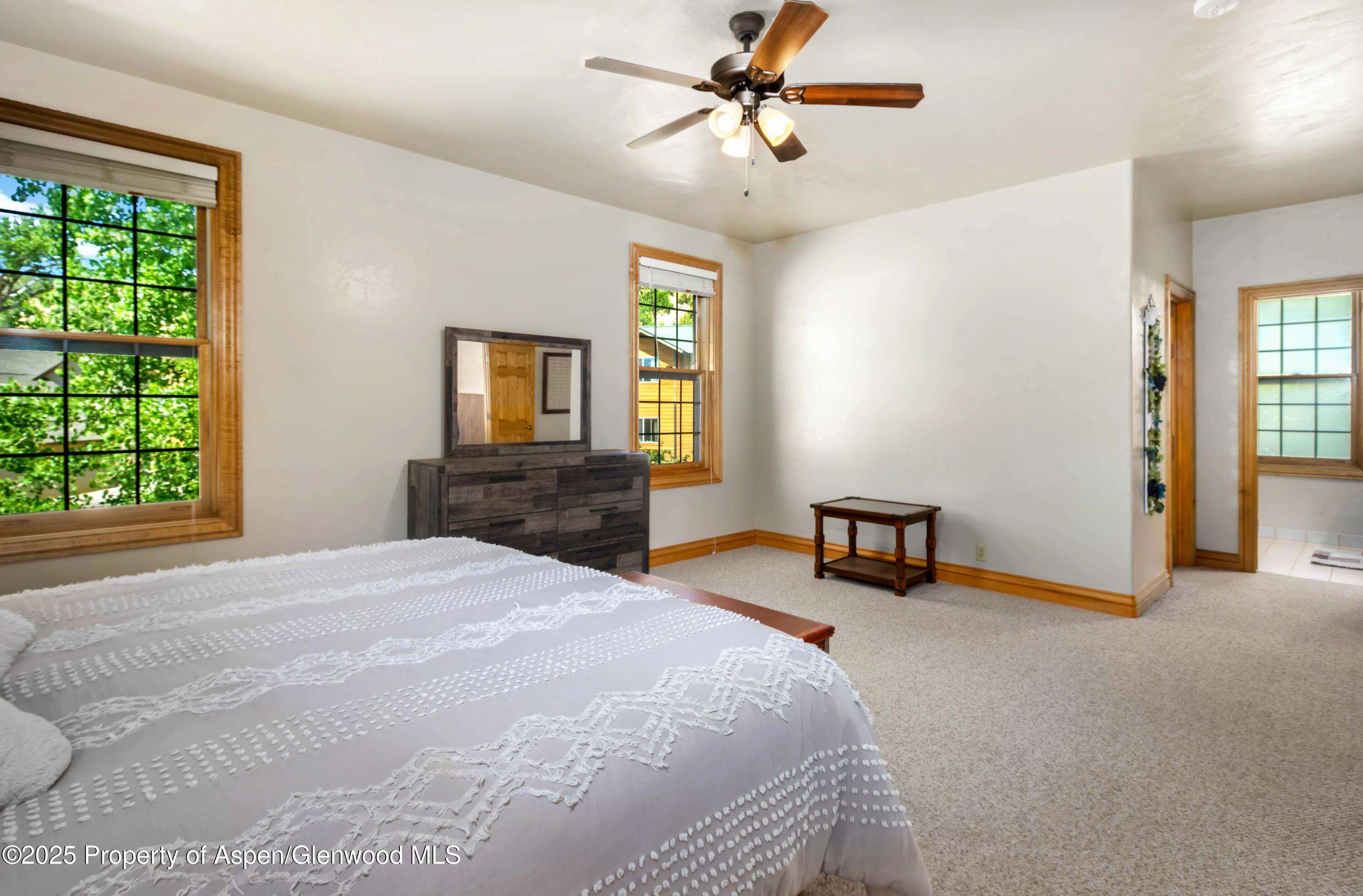 2687 Fairview Heights Court Rifle, CO 81650 - Photo 20 of 40 a bedroom with a bed and a chandelier
