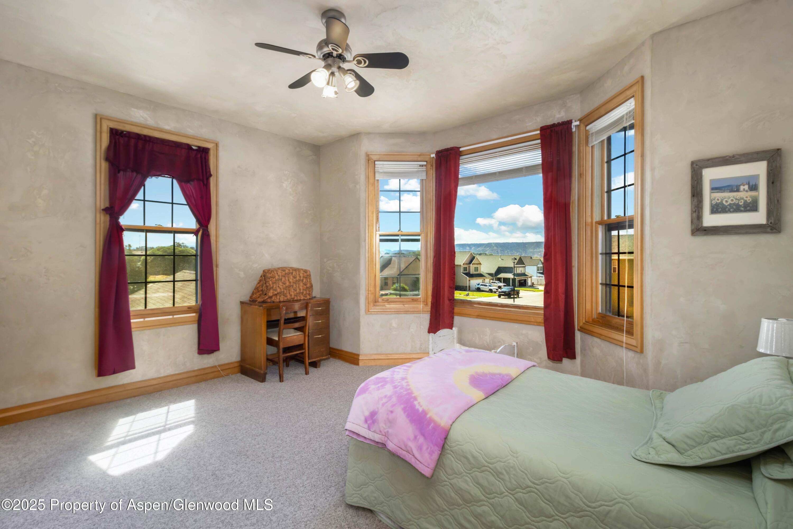 2687 Fairview Heights Court Rifle, CO 81650 - Photo 22 of 40 a bedroom with a bed couch and a window