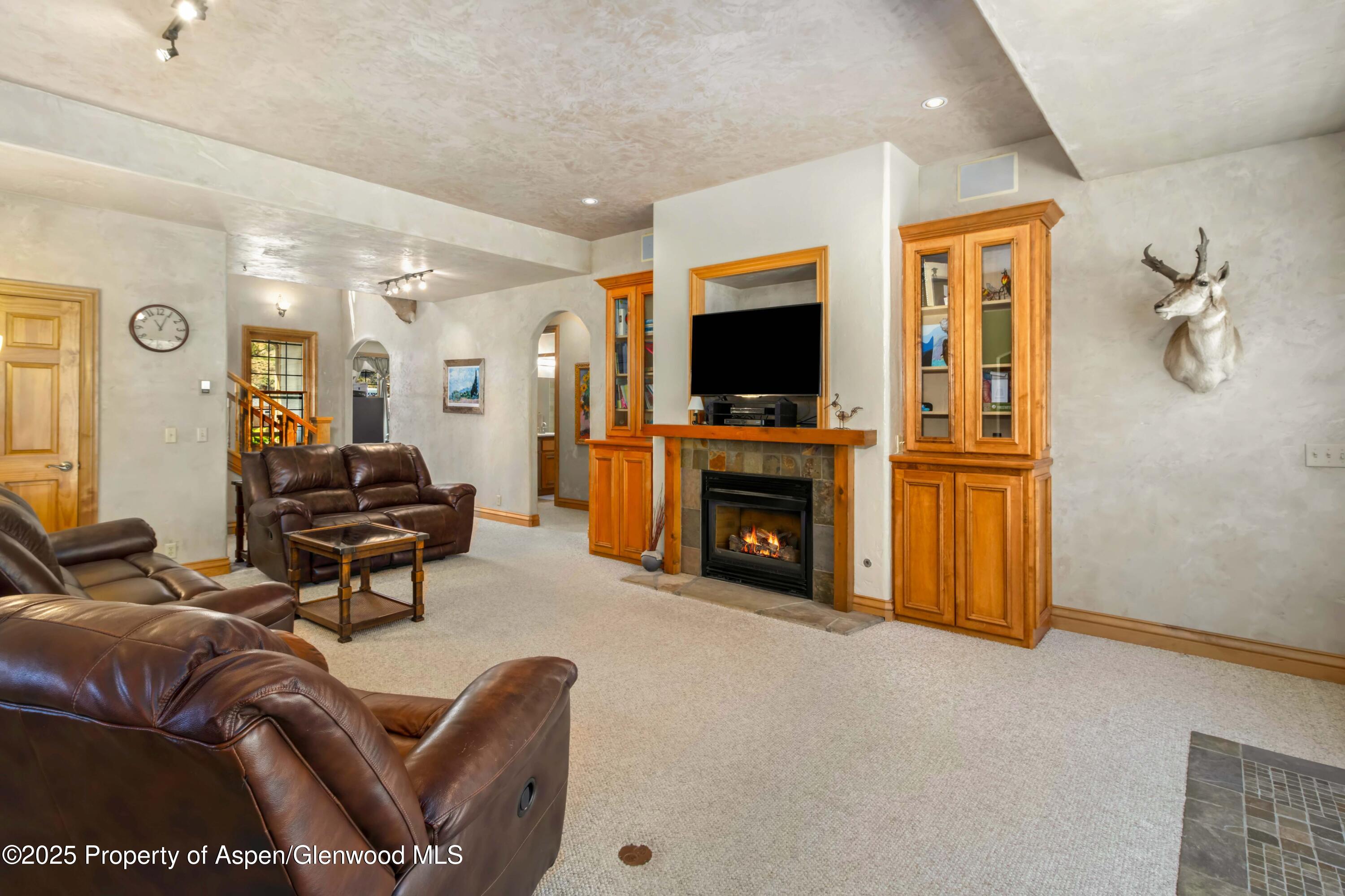 2687 Fairview Heights Court Rifle, CO 81650 - Photo 5 of 40 a living room with furniture a flat screen tv and a fireplace