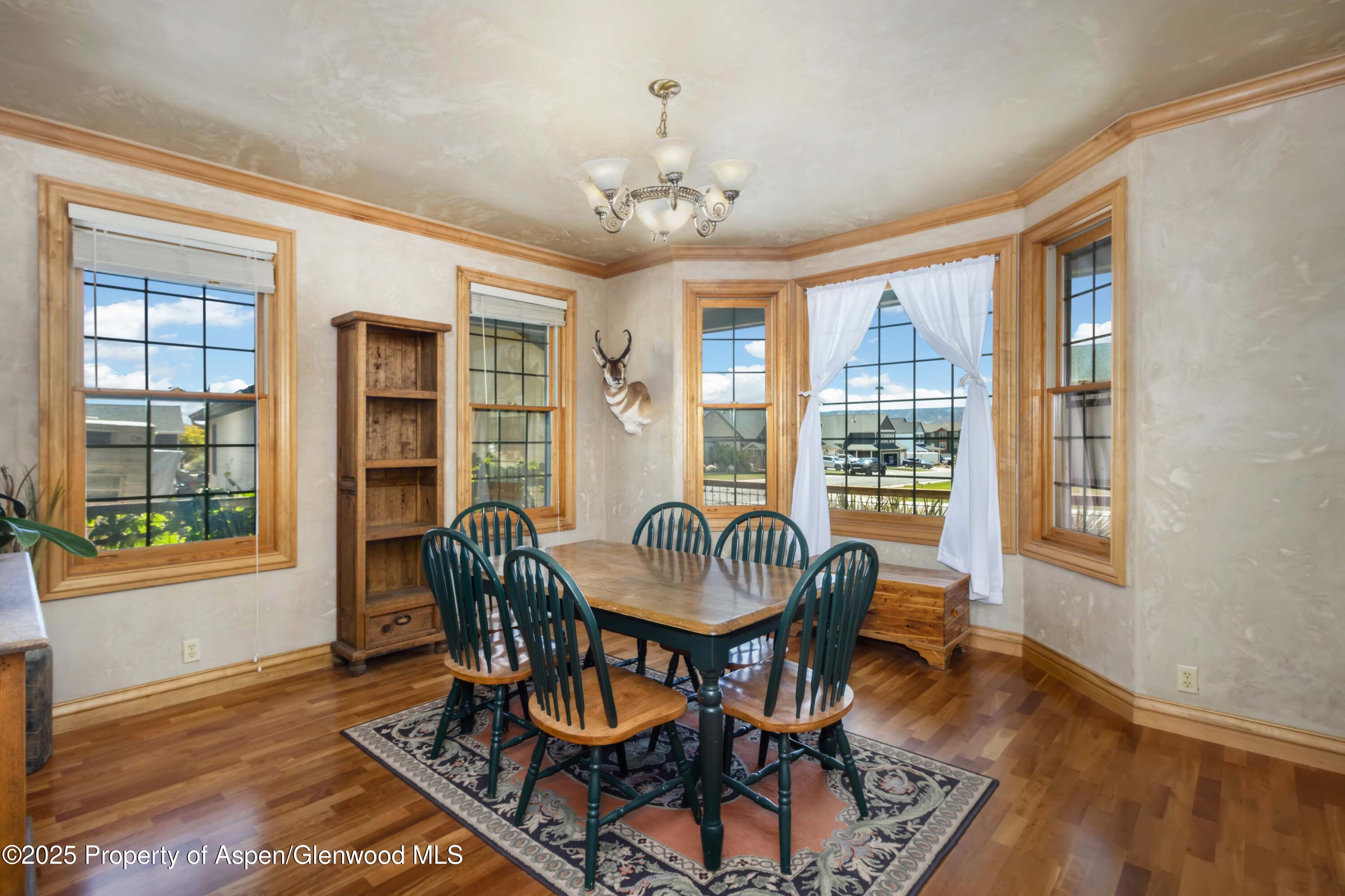 2687 Fairview Heights Court Rifle, CO 81650 - Photo 9 of 40 a dining room with furniture a chandelier and wooden floor