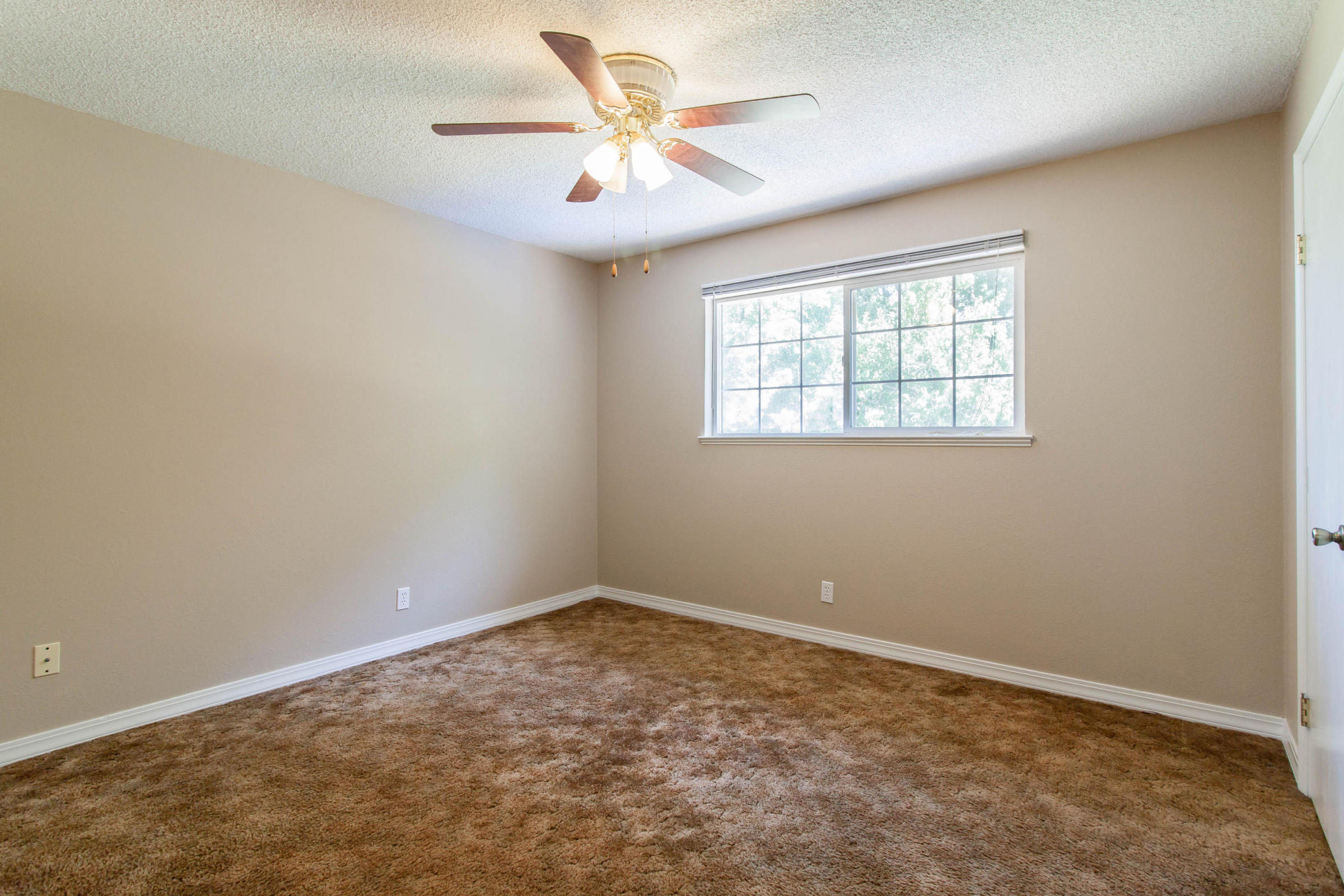 4801 Balls Ferry Road Anderson, CA 96007 - Photo 6 of 22 an empty room with a window and a fan