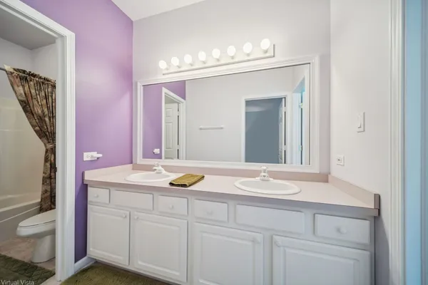 a bathroom with a sink vanity and mirror
