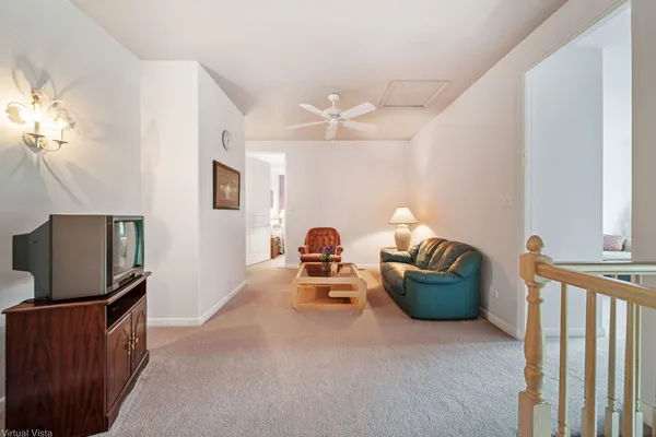 a living room with furniture a flat screen tv and a window