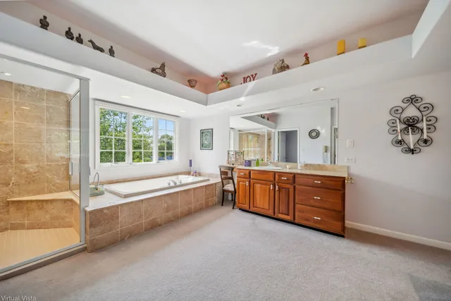 a large white tub sitting in a room next to a window