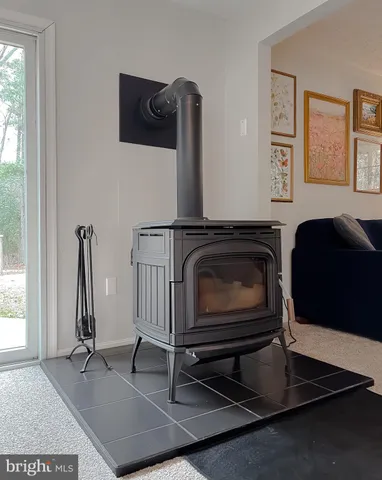 a living room with furniture a flat screen tv and a window