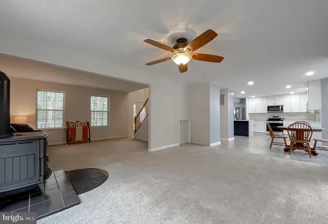 a view of a livingroom with furniture and a ceiling fan