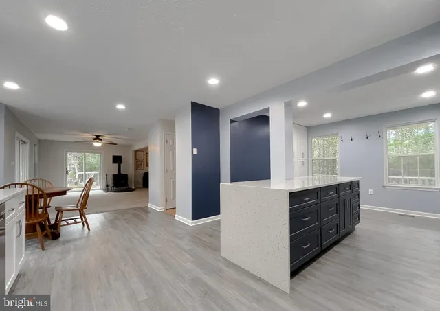 a kitchen with a sink cabinets and wooden floor