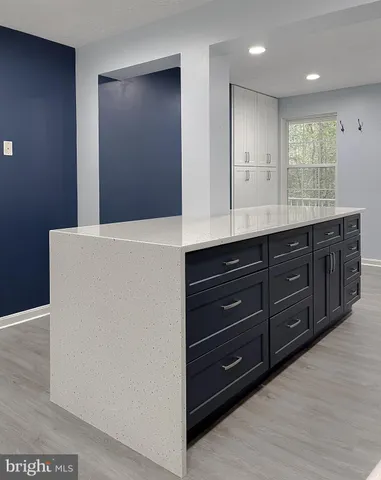 a view of staircase and living room with wooden floor