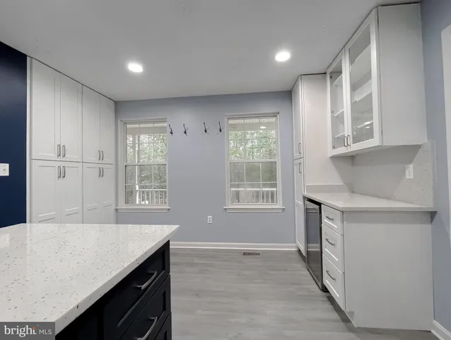 a spacious bedroom with a bed and a chandelier